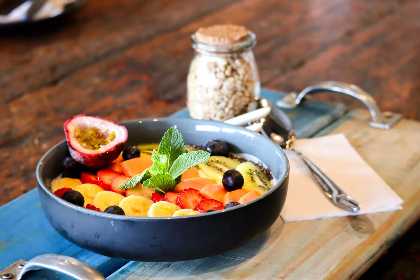 A fresh fruit health bowl with granola, berries and mint.
