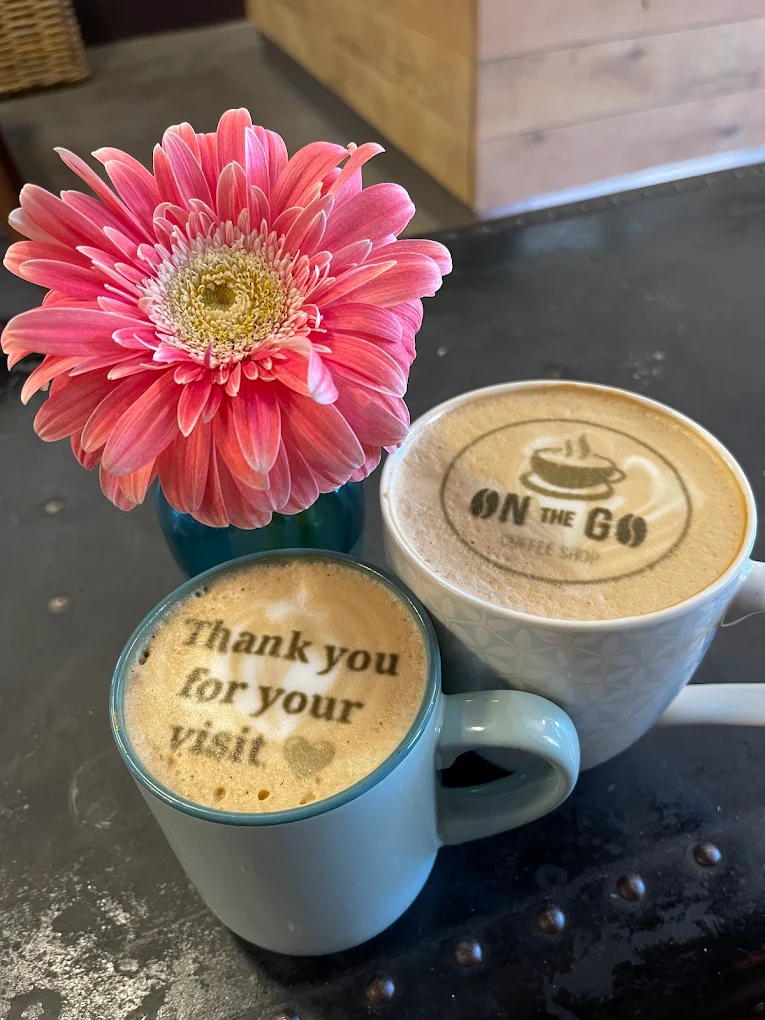 A cappuccino with the On The Go logo stencilled in the foam.
